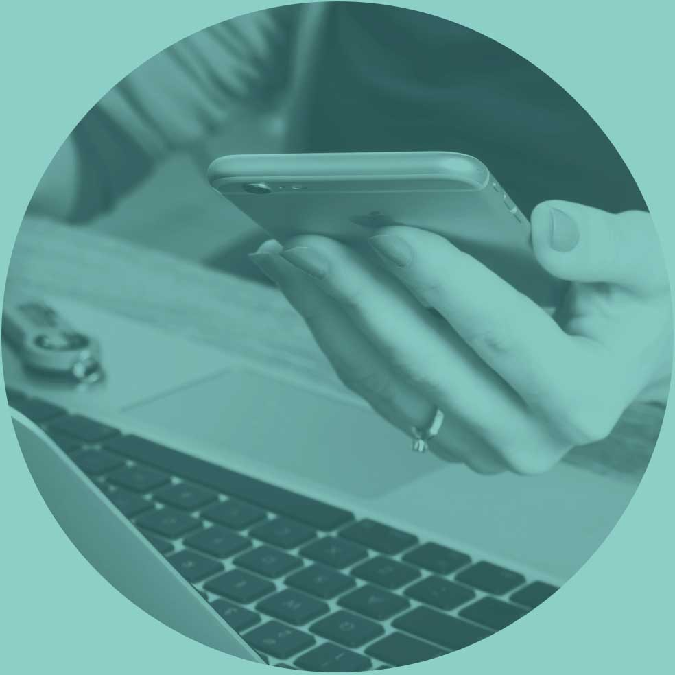 Person using a laptop and phone